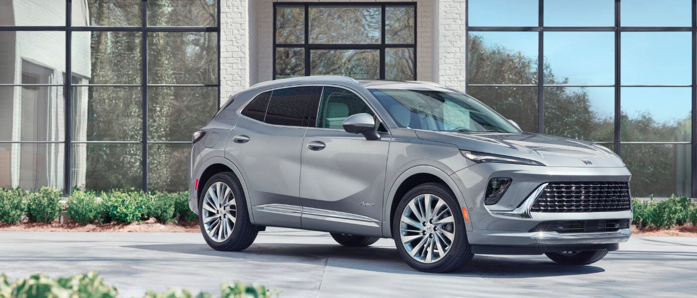 2026 Buick Envision parked by wall of windows