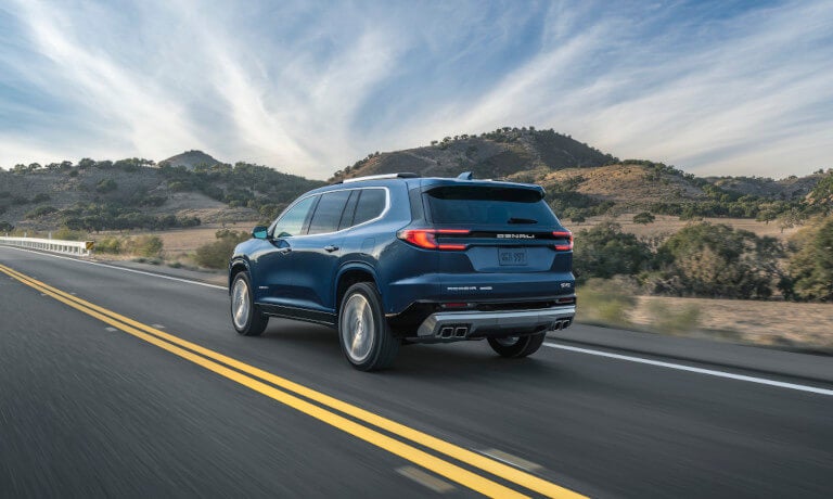 2026 GMC Acadia driving away on highway