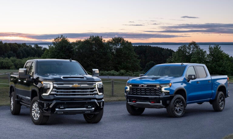 2025 Chevy Silverado 2500 pair parked near lake