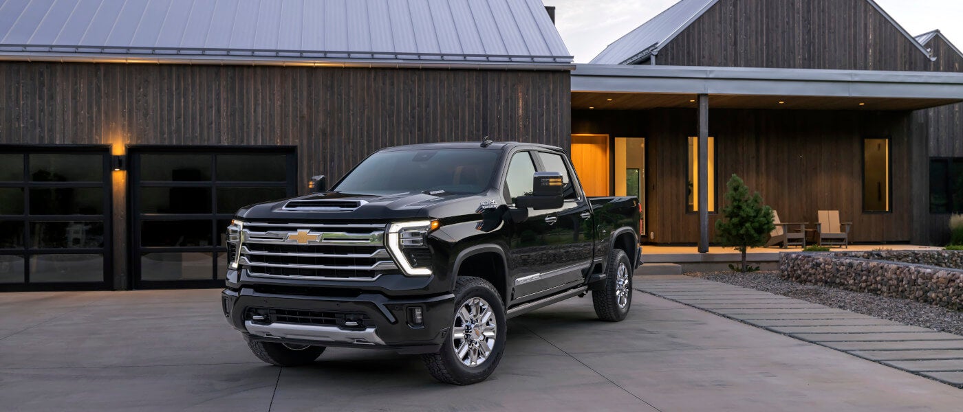 2026 Chevy Silverado 2500 HD parked outside a house at dusk